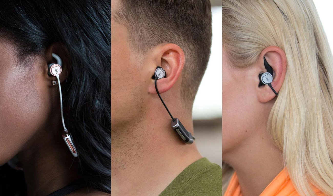 Zipbuds 26 Sport Headphones are inserted in the ears of three people.
